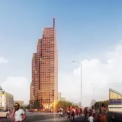 Pomarańczowy wieżowiec o kaskadowej formie, z zielonymi akcentami, dominuje nad ulicą. Zastanawiasz się, ile metrów ma ten wieżowiec?