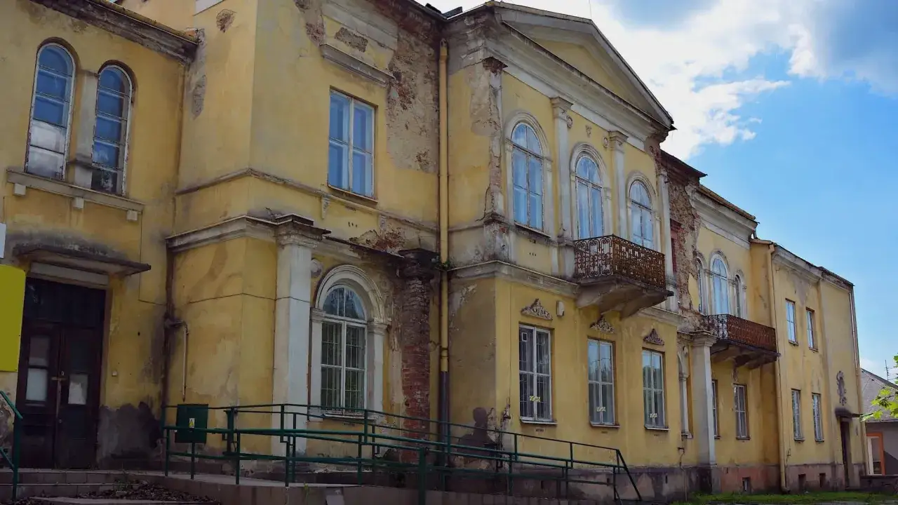 Żółty, zniszczony budynek z balkonami. Czy taki dom, aby był zabytkiem, musi mieć co najmniej 100 lat?